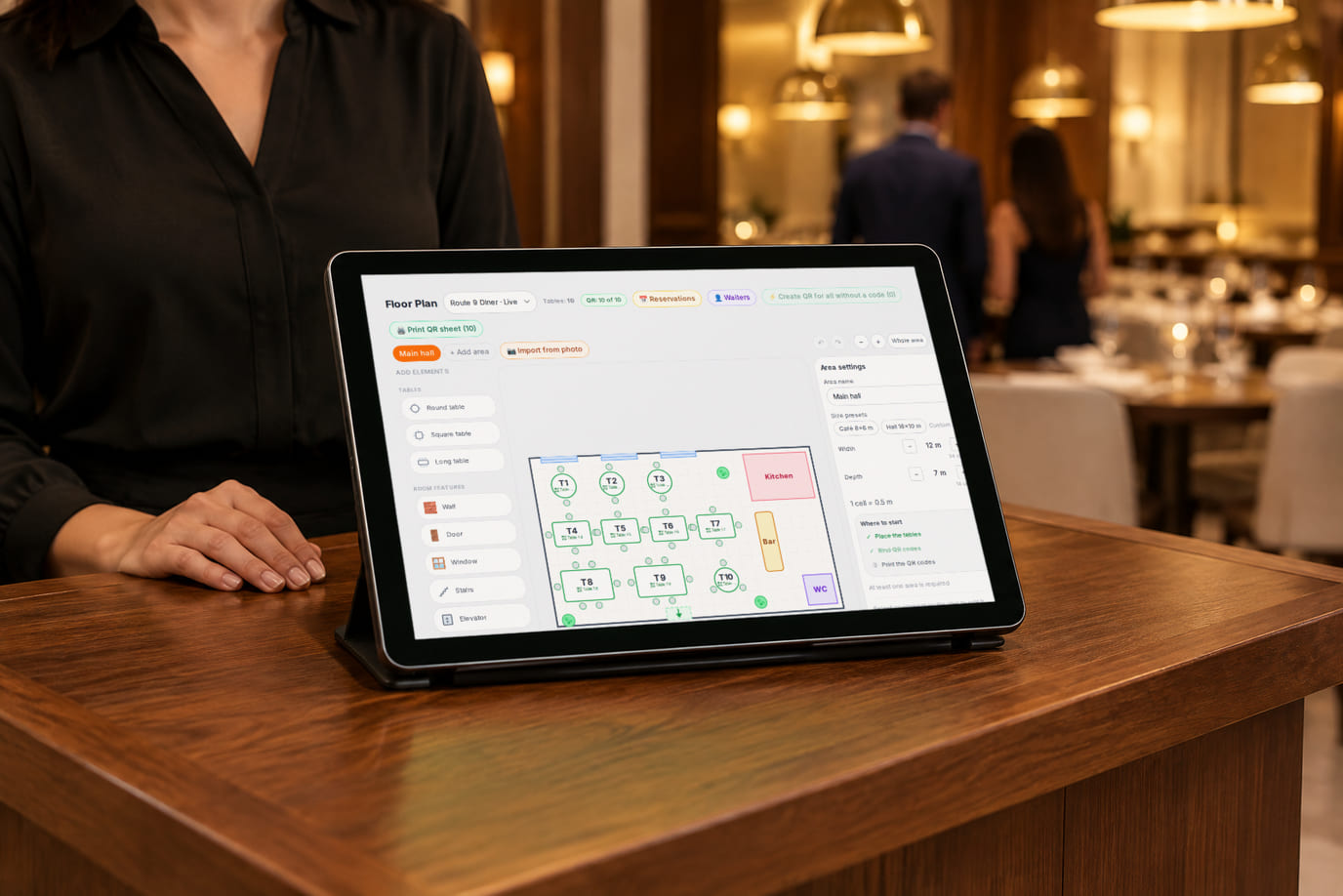 A host at the restaurant entrance stand with a tablet showing the floor plan and tables